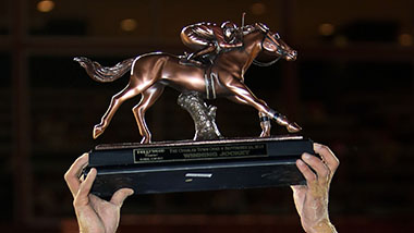 Jockey holding horse statue prize