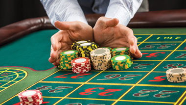 dealer pushing chips