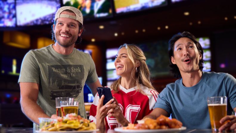 Picture of men and women in The Sportsbook eating and drinking