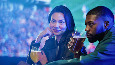 couple watching the game on a big screen