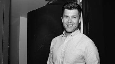 A black and white photo pf Colin Jost.