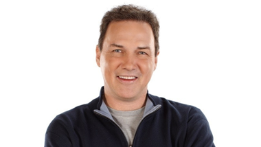 Norm Macdonald in navy pullover sweater