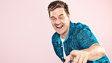 Comedian Jim Breuer pointing at the camera laughing.