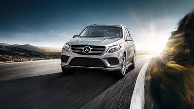 A photo of a Mercedes on the road.