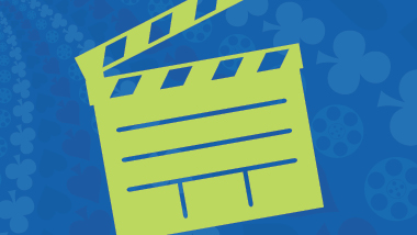 Green movie clapperboard against a blue swirling background