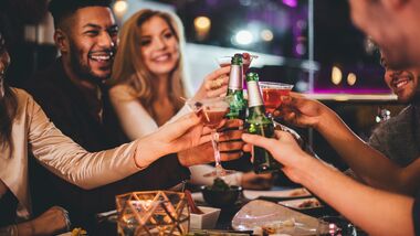 A group of friends sharing a drink as they celebrate New Year's Eve